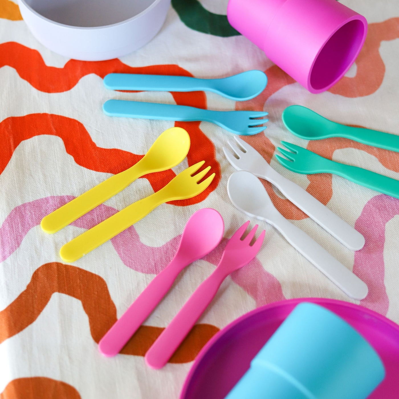 Bamboo plant-based cutlery & cups sitting on a tablecloth