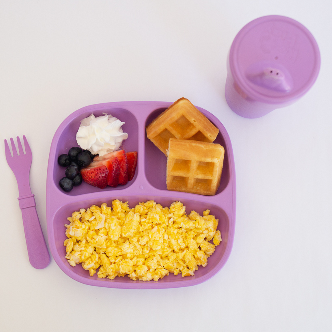 Purple divided plate with waffles, cereal, fruit, and a purple cup on a white background RePlay Recycled Divided Plate - Purple